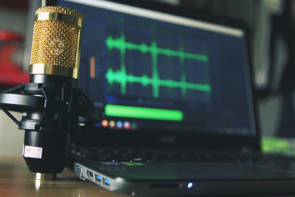 pexels-photo-755416-755416-1 Close-up of a golden microphone and laptop used for audio editing.